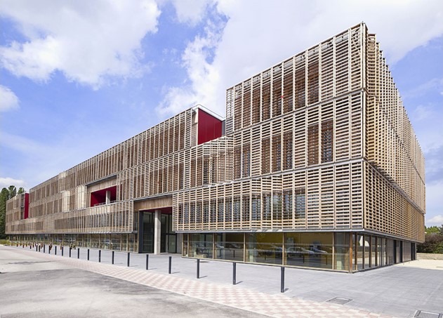 The Innovation center is a large building with striped, wooden walls.